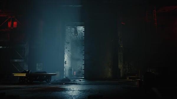 ILL game screenshot: A dimly lit industrial room with a large metal door, scattered debris, and red lights casting eerie shadows.