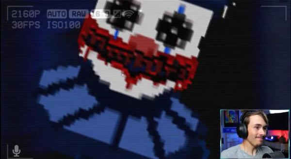 Screenshot from 'The Last Night' game showing a pixelated character with a red smile and distorted eyes, resembling a creepy clown.