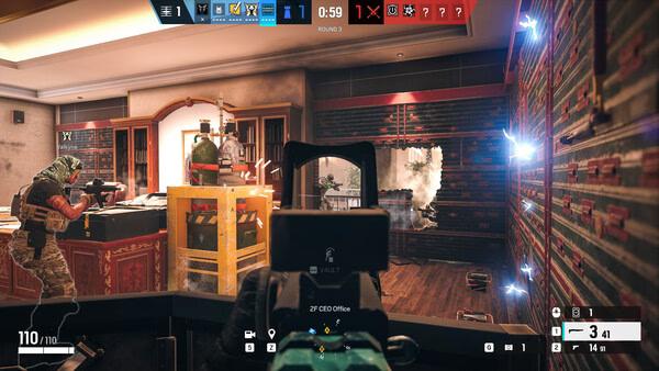 Screenshot from Tom Clancy's Rainbow Six Siege showing players in combat with barricades and weapons in an office setting.