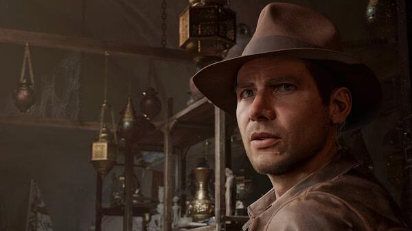 Screenshot from Indiana Jones and the Great Circle showing a hat-wearing adventurer in a dimly lit room with artifacts.