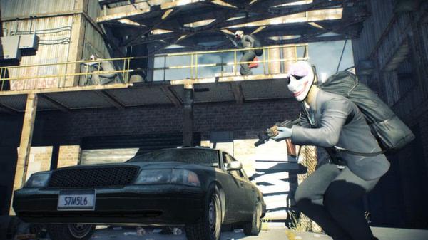 PAYDAY 2 screenshot: A masked robber holding a gun crouches near a car, while others stand on a warehouse balcony above.