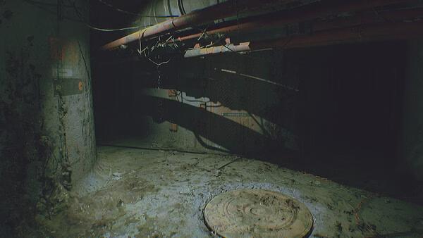 A screenshot from ROUTINE showing a dimly lit, decayed industrial corridor with pipes, wires, and a circular hatch on the floor.