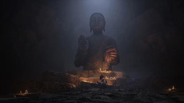 Screenshot from WUCHANG: Fallen Feathers showing a lone figure kneeling near a large stone statue surrounded by glowing candles.