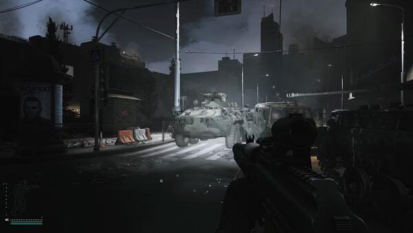 Escape from Tarkov screenshot: A player aims at armored vehicles on a dark, urban street illuminated by streetlights.