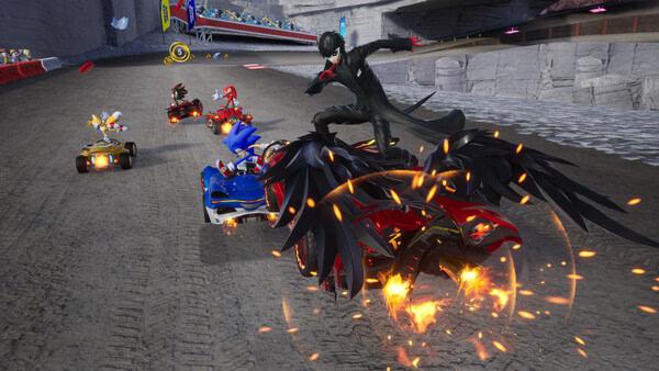 Sonic Racing: CrossWorlds screenshot showing Sonic, Knuckles, and others racing on a track, with dynamic vehicles and fiery effects.