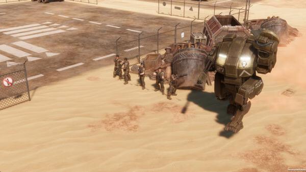 Screenshot from MENACE showing a group of soldiers advancing alongside a large mech on a sandy desert with a fence in the background.