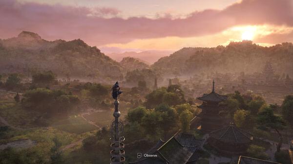 Assassin’s Creed Shadows screenshot: A character stands atop a tall spire, overlooking a scenic landscape at sunset.