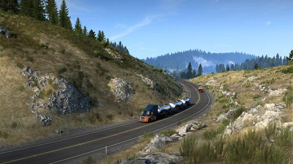Screenshot from American Truck Simulator featuring a truck hauling tank trailers on a scenic, winding road with hills and trees.