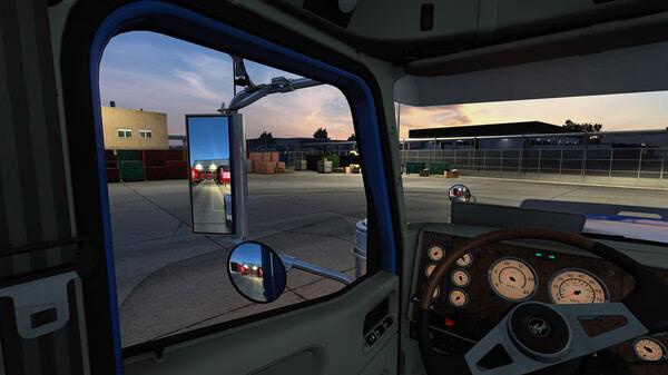Interior cabin view of a truck at sunset in American Truck Simulator, showing dashboard and side mirror. Screenshot.