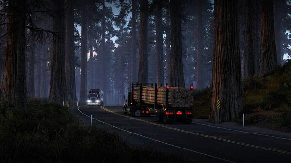 American Truck Simulator screenshot: A truck carrying logs drives through a dense forest on a winding road at dusk.