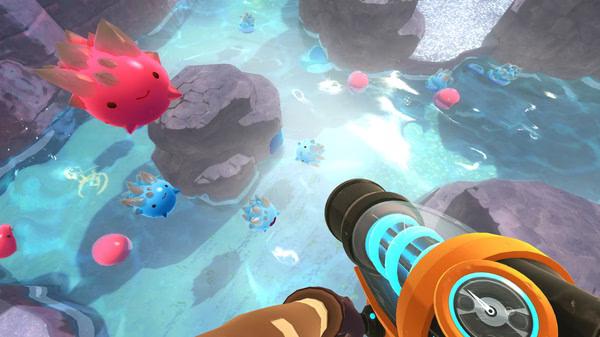 Slime Rancher screenshot: A player aims a Vacpack at various colorful slimes swimming in a vibrant, rocky pool environment.