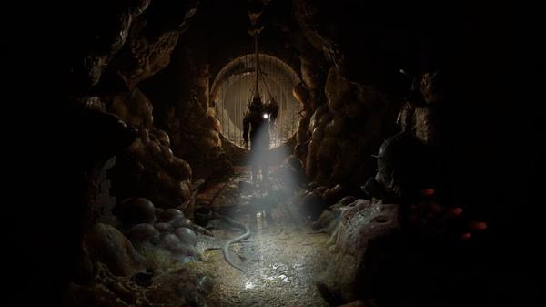 Screenshot from Half-Life: Alyx showing a dark, eerie tunnel with Alyx Vance silhouetted against glowing light, surrounded by rocky walls.