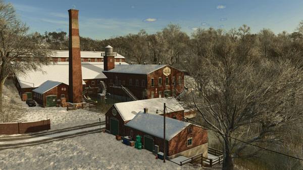 Screenshot from Farming Simulator 25 showing a snow-covered farm with brick buildings and bare trees in a winter landscape.