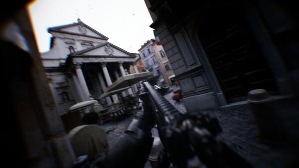 Screenshot from the game Bodycam shows a first-person view aiming a rifle down a cobblestone street with historic buildings in the background.
