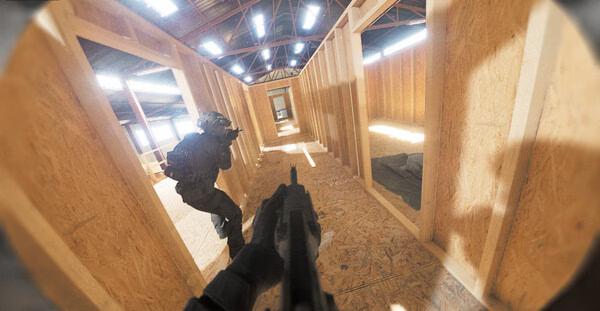 Screenshot from the game Bodycam shows a first-person view of a soldier aiming a gun at another soldier in a wooden corridor.
