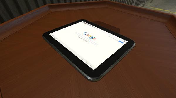 A Tabletop Simulator screenshot showing a tablet displaying the Google homepage on a wooden game table.