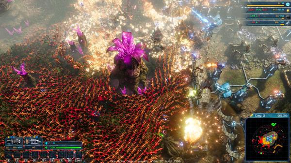 Screenshot from The Riftbreaker showing a base under attack by swarms of creatures and a giant plant-like enemy in a vibrant battlefield.