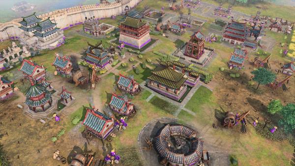 Screenshot of Age of Empires IV showing a bustling medieval Asian village with colorful buildings and a protective wall in the background.