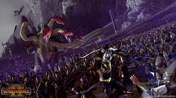 Screenshot from Total War: WARHAMMER II showing soldiers battling a giant hydra amidst a forested landscape.