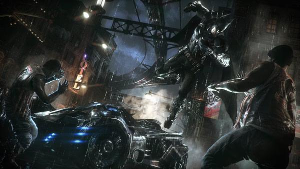 Batman: Arkham Knight screenshot. Batman leaps in a rainy street, facing two foes beside the Batmobile.
