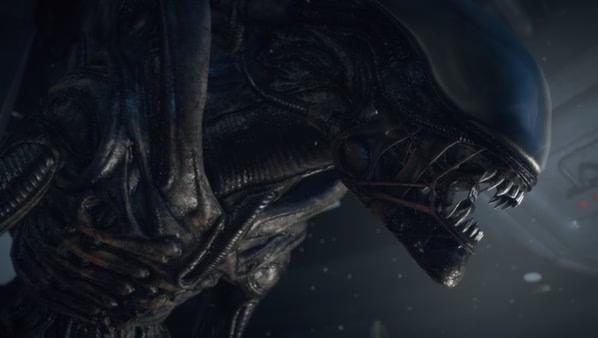 Screenshot from Alien: Isolation showing a close-up of a menacing Xenomorph with its mouth open in a dark, eerie environment.