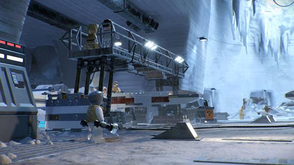 Screenshot from LEGO Star Wars: The Skywalker Saga showing a snowy base with LEGO characters and equipment in an icy cave.