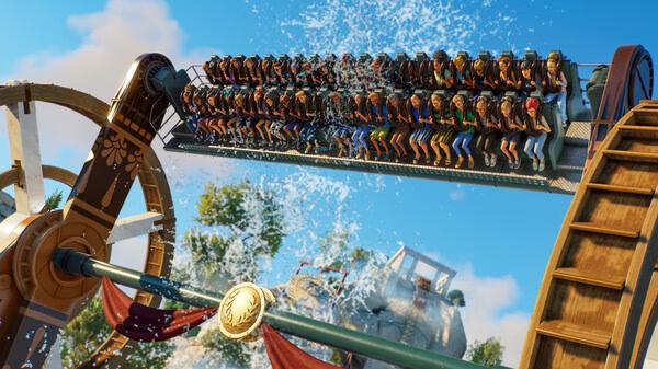 Planet Coaster 2 screenshot: A thrilling water ride with passengers drenched by splashing waves under a sunny sky.