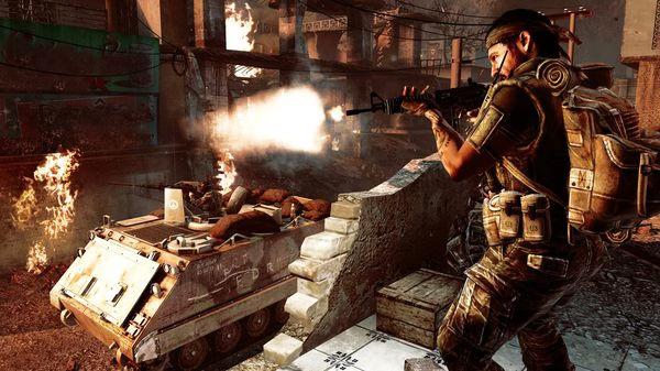 Screenshot from Call of Duty: Black Ops showing a soldier firing a weapon near a burning armored vehicle.
