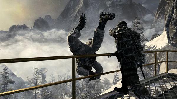Call of Duty: Black Ops screenshot featuring a soldier kicking another soldier off a snowy mountain platform.