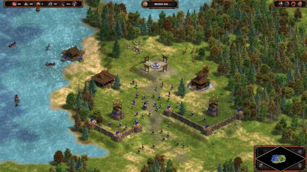 Screenshot of Age of Empires Definitive Edition showing a village with walls, soldiers, and a river nearby.