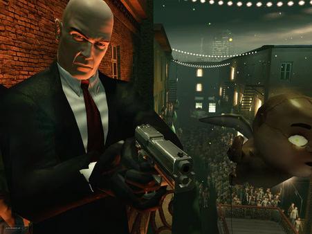 Hitman: Blood Money screenshot showing Agent 47 holding a gun, overlooking a crowded street with hanging lights and decorations.