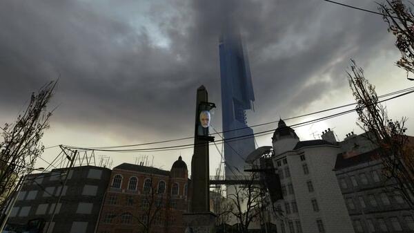Half-Life 2 screenshot: A cityscape with a tall tower displaying a man's face, surrounded by ominous clouds and urban buildings.