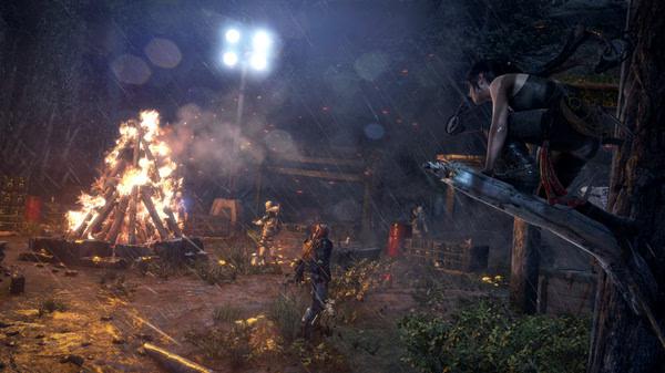 Screenshot from Rise of the Tomb Raider showing a character perched on a tree, observing a campfire scene in a rainy forest.
