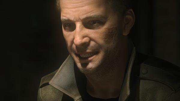 Screenshot from Rise of the Tomb Raider showing a character in a dark jacket, with a dimly lit, shadowy background.