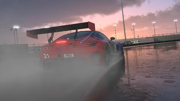 Screenshot from iRacing shows a race car driving through a wet track at sunset, with rear lights glowing in the mist.