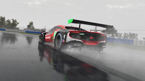 iRacing screenshot: A sleek race car speeds through a wet track, leaving a trail of mist behind, with trees visible in the background.