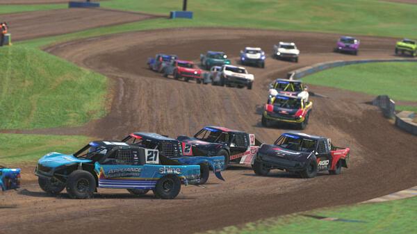 Screenshot from iRacing shows multiple off-road trucks racing on a dirt track, kicking up dust as they navigate a sharp turn.
