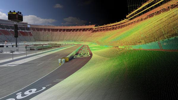 A screenshot from iRacing showing a race track under development with colorful laser scan data mapping the surface.