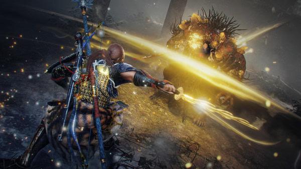 A Nioh 2: Complete Edition screenshot shows a warrior with swords fighting a fiery beast, emitting a bright yellow energy.