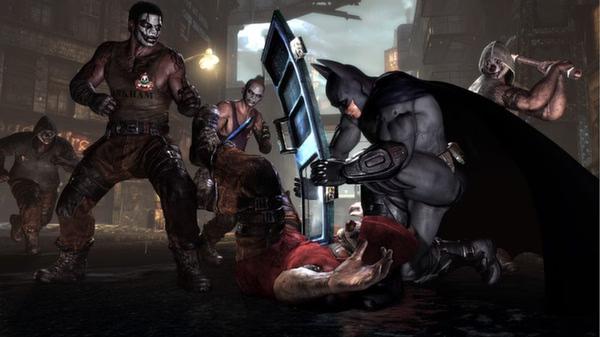 Batman: Arkham City screenshot. Batman blocks an incoming attack with a shield while surrounded by multiple thugs in a dark alley.