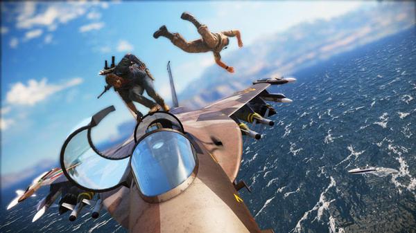Just Cause 3 screenshot: Two characters in mid-air action atop a jet plane flying over the ocean, with a boat visible below.