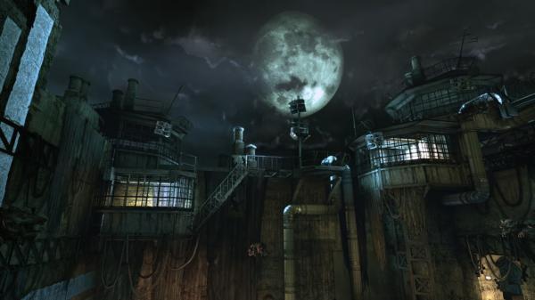 Screenshot from Batman: Arkham Asylum shows the exterior of Arkham Asylum under a full moon, with dark clouds in the sky.