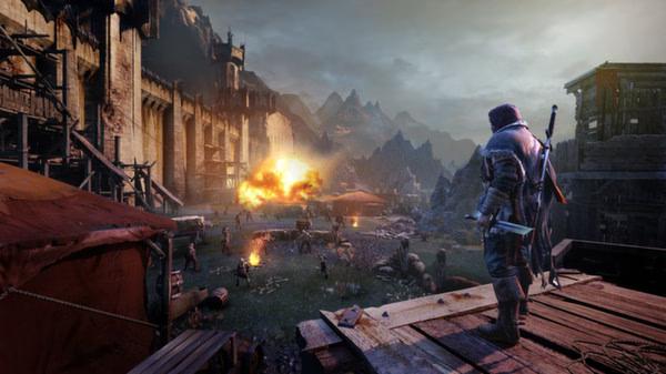 A Middle-earth: Shadow of Mordor screenshot showing a lone warrior overlooking a battlefield with an explosion in the distance.