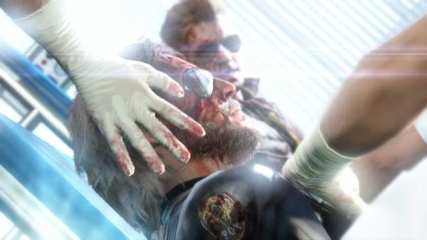 Screenshot from Metal Gear Solid V: The Phantom Pain showing a scene where a medic examines a wounded character wearing an eye patch.