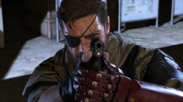 Screenshot from Metal Gear Solid V: The Phantom Pain showing a character with a robotic arm aiming a weapon indoors.