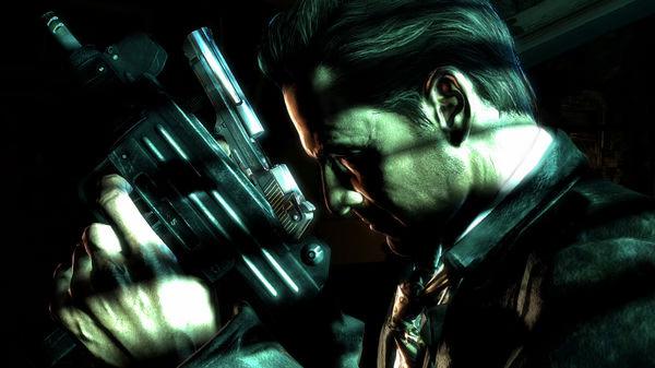 Max Payne 3 screenshot: Close-up of Max Payne holding a weapon, illuminated by dramatic lighting in a dark setting.