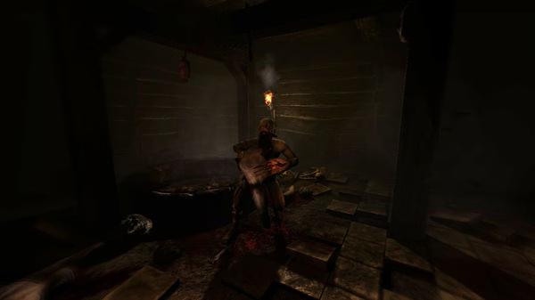 Screenshot from Amnesia: The Dark Descent showing a dimly lit room with a figure holding a torch near a wooden table and scattered objects.
