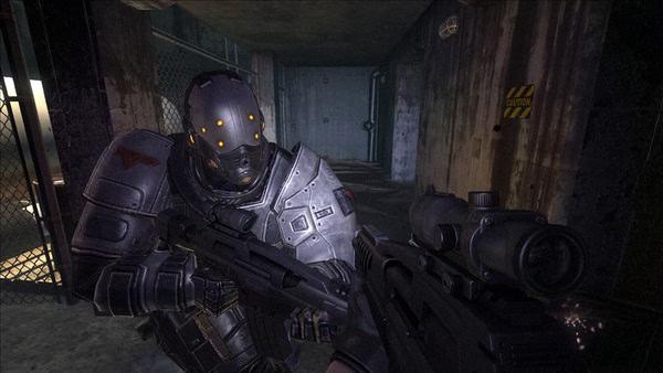 F.E.A.R. 2: Project Origin screenshot showing a soldier in futuristic armor aiming a weapon in a dimly lit corridor.