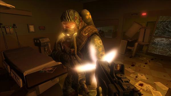F.E.A.R. 2: Project Origin screenshot showing a soldier in a gas mask firing a weapon in a dimly lit, chaotic hospital room.
