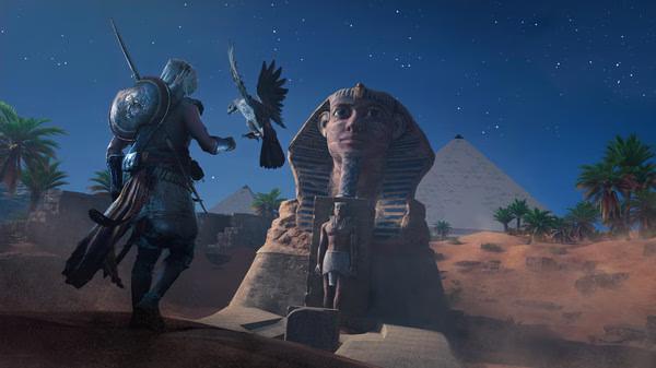 Screenshot from Assassin's Creed Origins showing a character interacting with a bird in front of a sphinx at night.